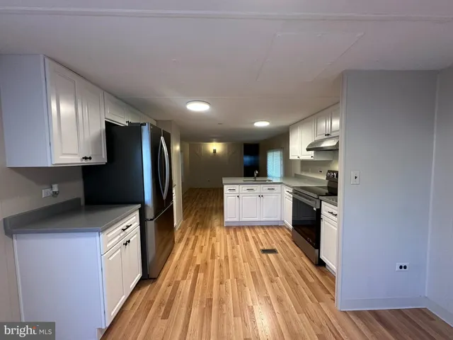 a kitchen with stainless steel appliances a refrigerator and a stove top oven