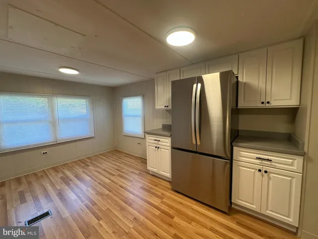 a kitchen with a refrigerator and a stove top oven
