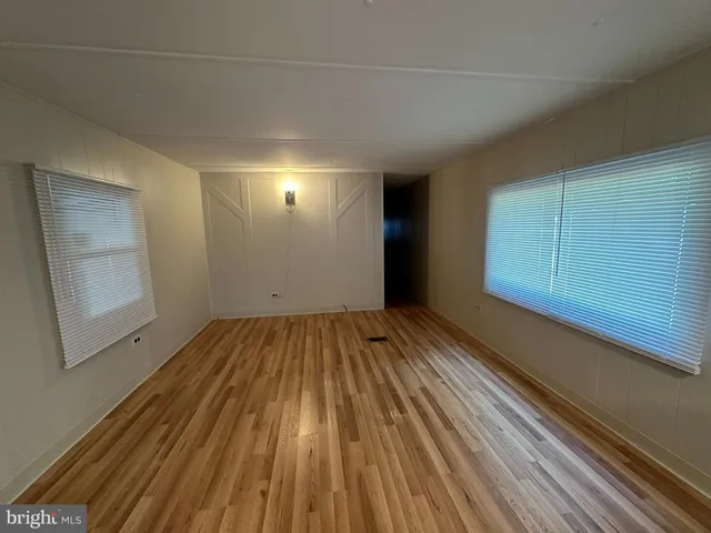 a view of a room with wooden floor and staircase