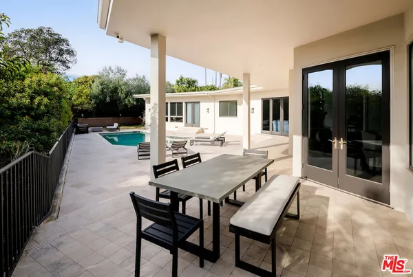 a swimming pool with outdoor seating and yard