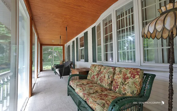 a view of a dining room with furniture large windows and wooden floor
