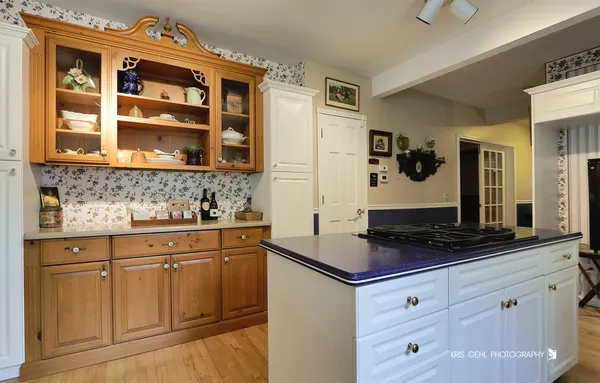 a kitchen with stainless steel appliances granite countertop a sink a stove and a wooden floors