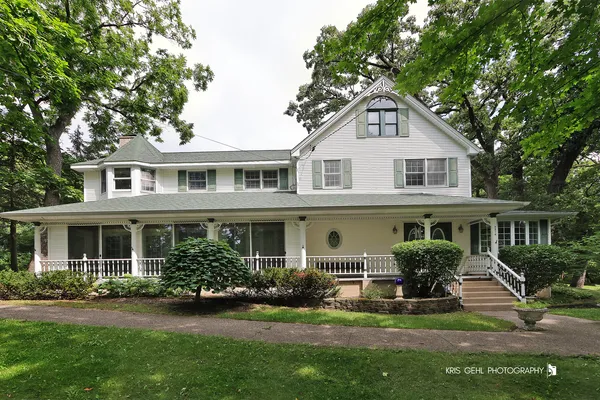 an aerial view of a house with backyard