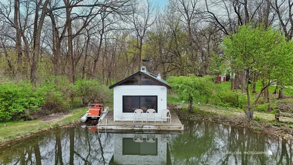 an aerial view of a house with a yard basket ball court and outdoor seating