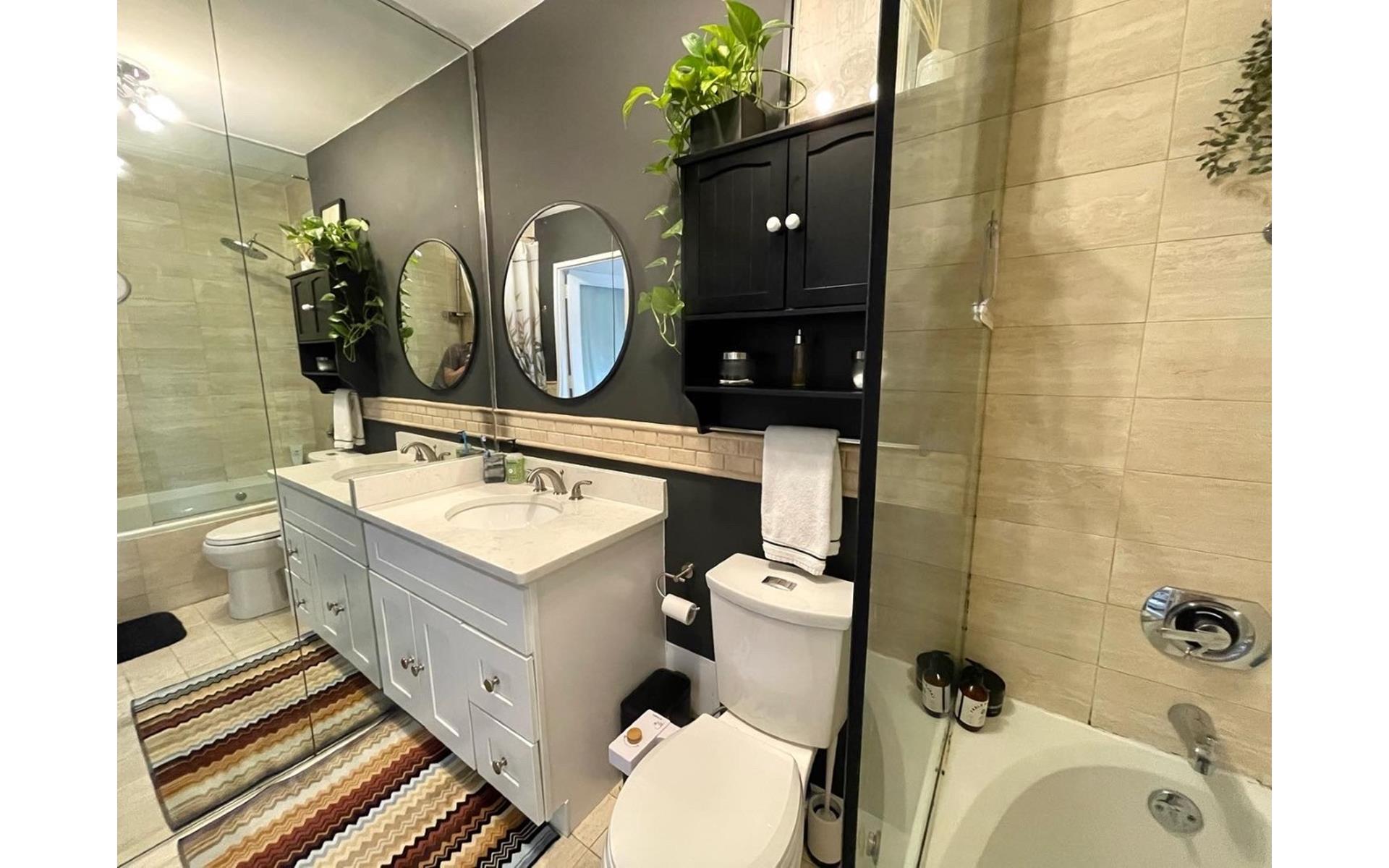 200 East 61st Street, Unit 20A Manhattan, NY 10065 - Photo 9 of 10 a bathroom with a sink mirror vanity and toilet