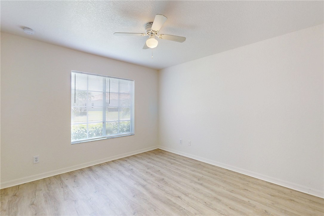 5563 55th Terrace Vero Beach, FL 32967 - Photo 21 of 36 an empty room with wooden floor and windows