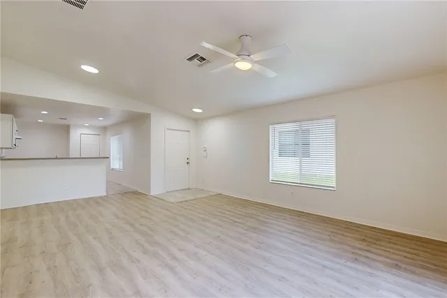 a view of a kitchen with a sink and a refrigerator