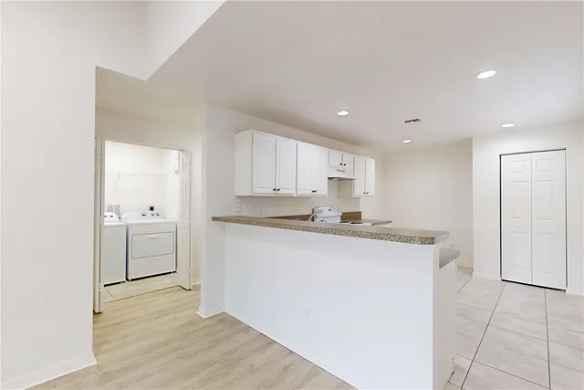 a kitchen with a stove sink and cabinets