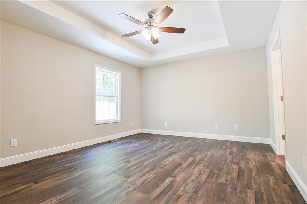 205 Perkins Road Dahlonega, GA 30533 - Photo 15 of 51 an empty room with wooden floor and windows