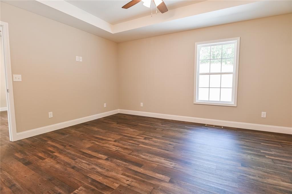205 Perkins Road Dahlonega, GA 30533 - Photo 16 of 51 an empty room with wooden floor and windows