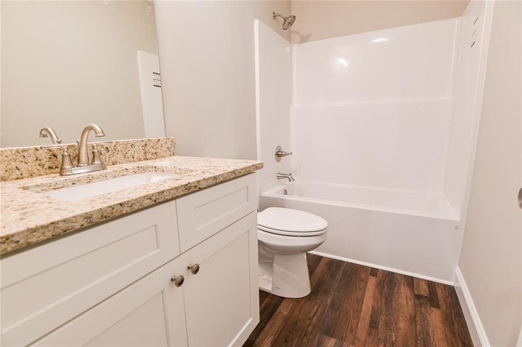 205 Perkins Road Dahlonega, GA 30533 - Photo 22 of 51 a bathroom with a granite countertop sink toilet and shower