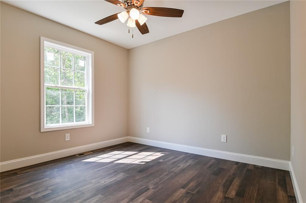 205 Perkins Road Dahlonega, GA 30533 - Photo 24 of 51 an empty room with wooden floor and windows