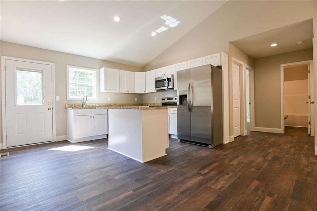 205 Perkins Road Dahlonega, GA 30533 - Photo 8 of 51 a kitchen with stainless steel appliances a refrigerator and wooden cabinets