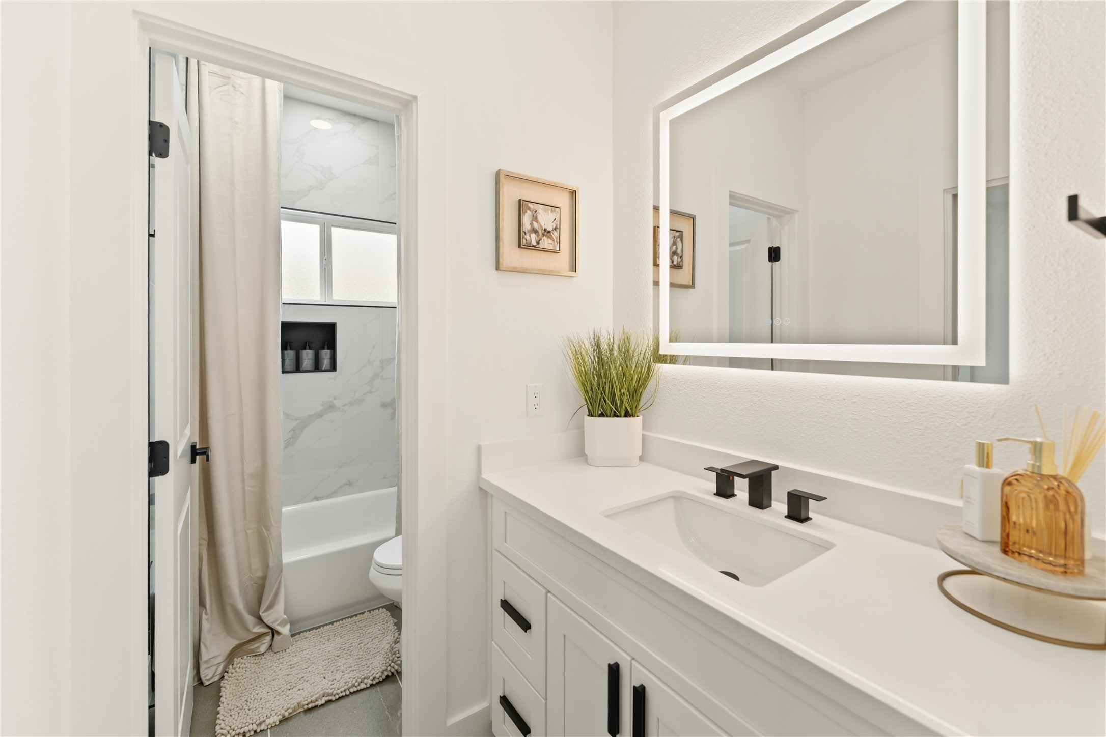 6539 Sealey Street Houston, TX 77091 - Photo 24 of 28 a bathroom with a sink and a mirror