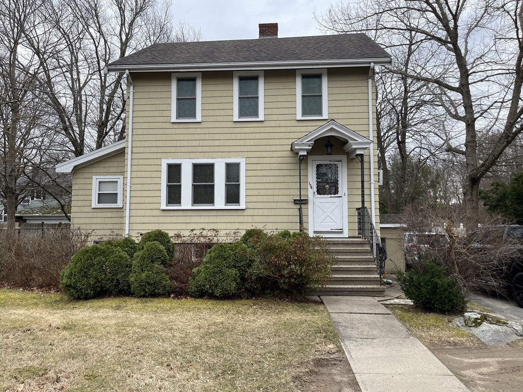 a front view of a house with a garden