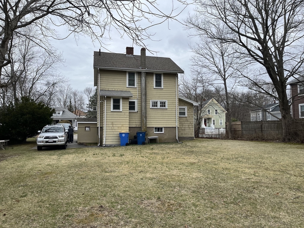 136 West Street Randolph, MA 02368 - Photo 12 of 13 a view of a house with a yard and a large tree