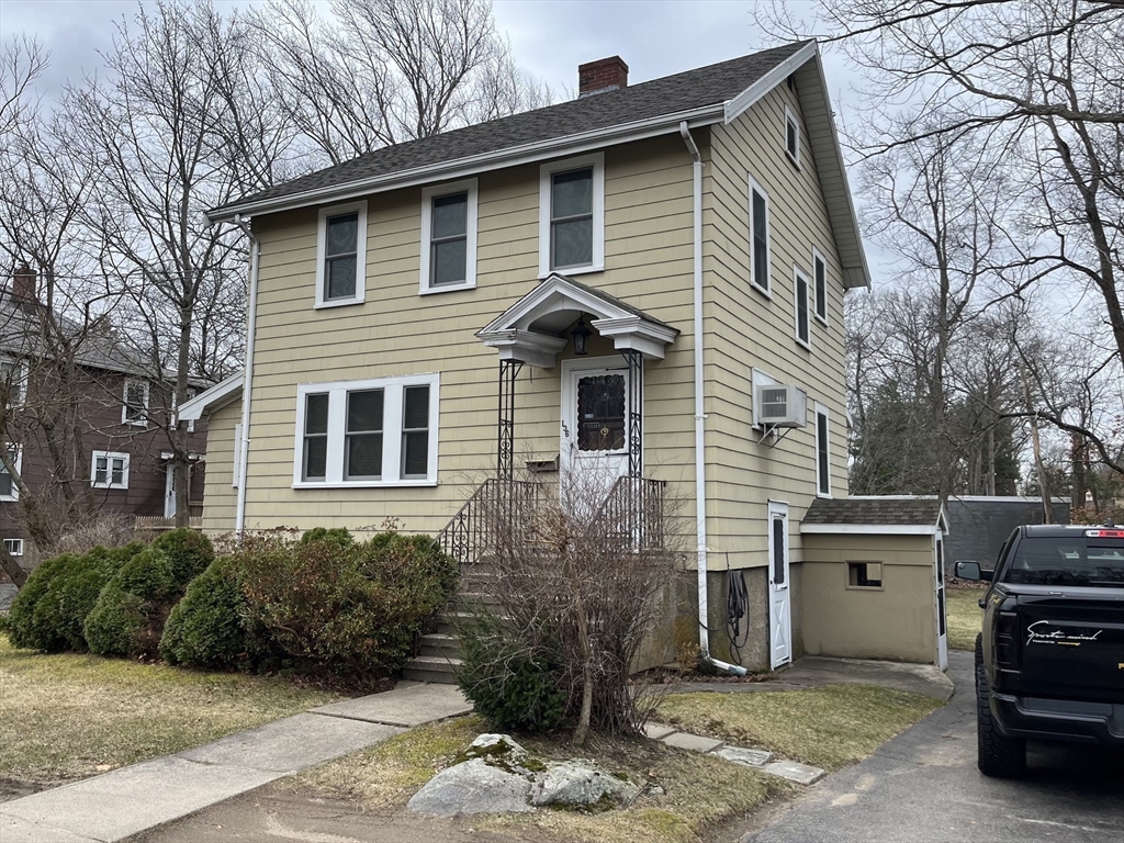 136 West Street Randolph, MA 02368 - Photo 2 of 13 a front view of a house with a yard