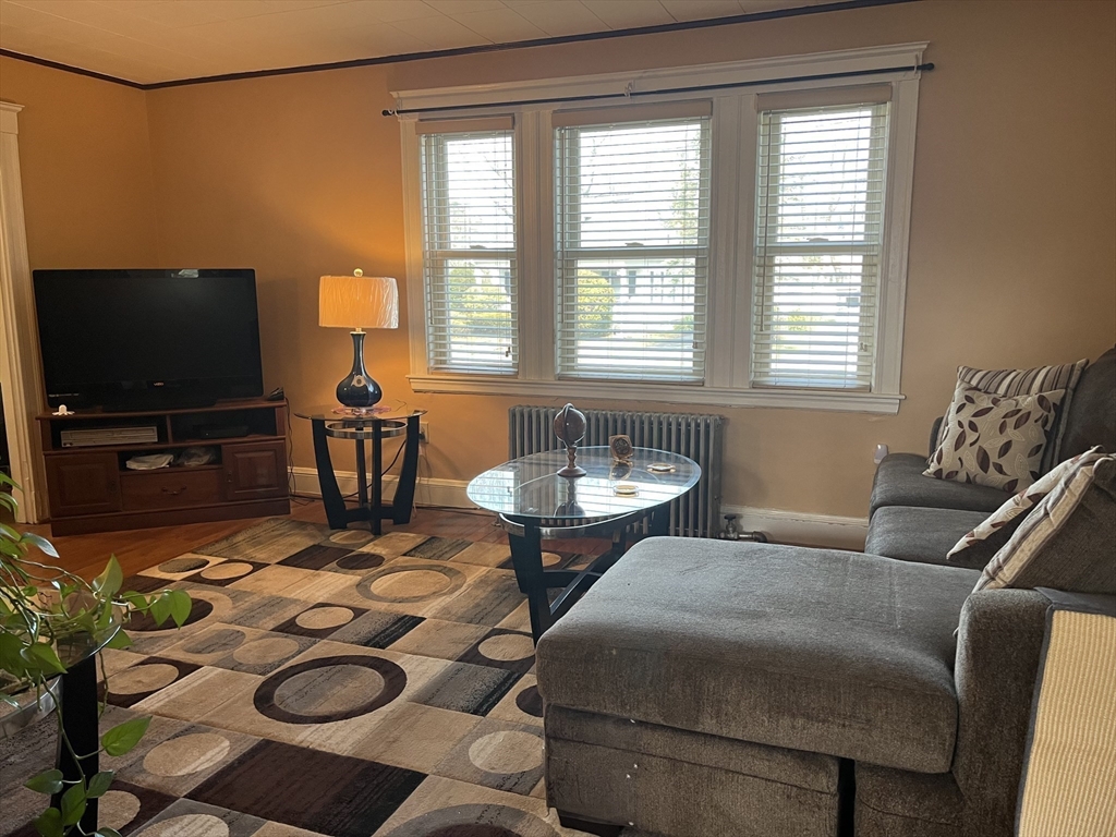 136 West Street Randolph, MA 02368 - Photo 4 of 13 a living room with furniture and a flat screen tv
