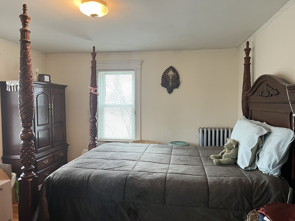 136 West Street Randolph, MA 02368 - Photo 6 of 13 a bedroom with a bed and wooden floor