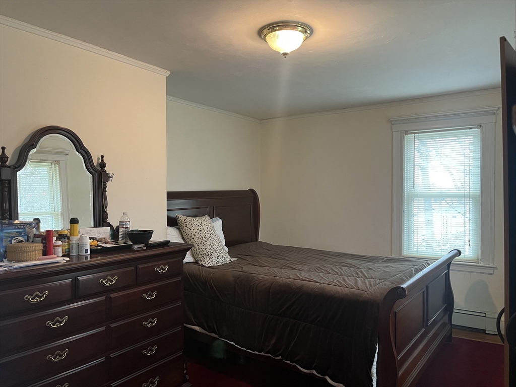136 West Street Randolph, MA 02368 - Photo 7 of 13 a bedroom with a bed and a dresser