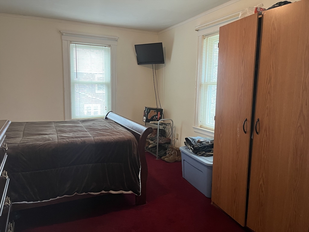 136 West Street Randolph, MA 02368 - Photo 8 of 13 a bedroom with a bed and a window