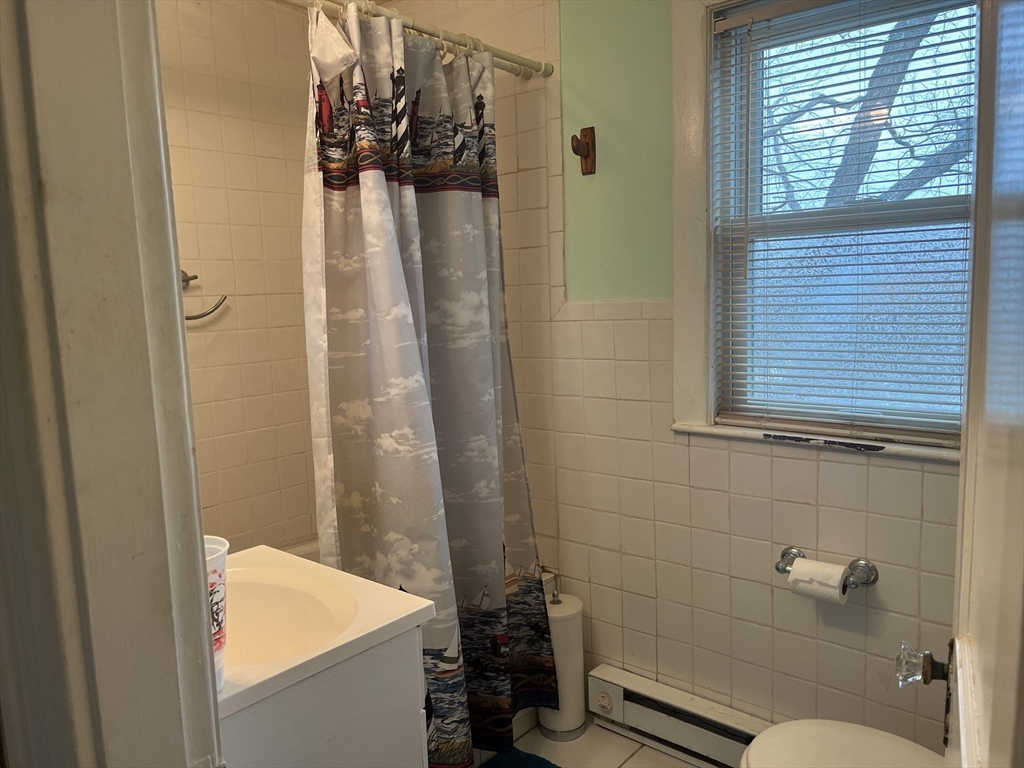 136 West Street Randolph, MA 02368 - Photo 9 of 13 a bathroom with a shower and a toilet
