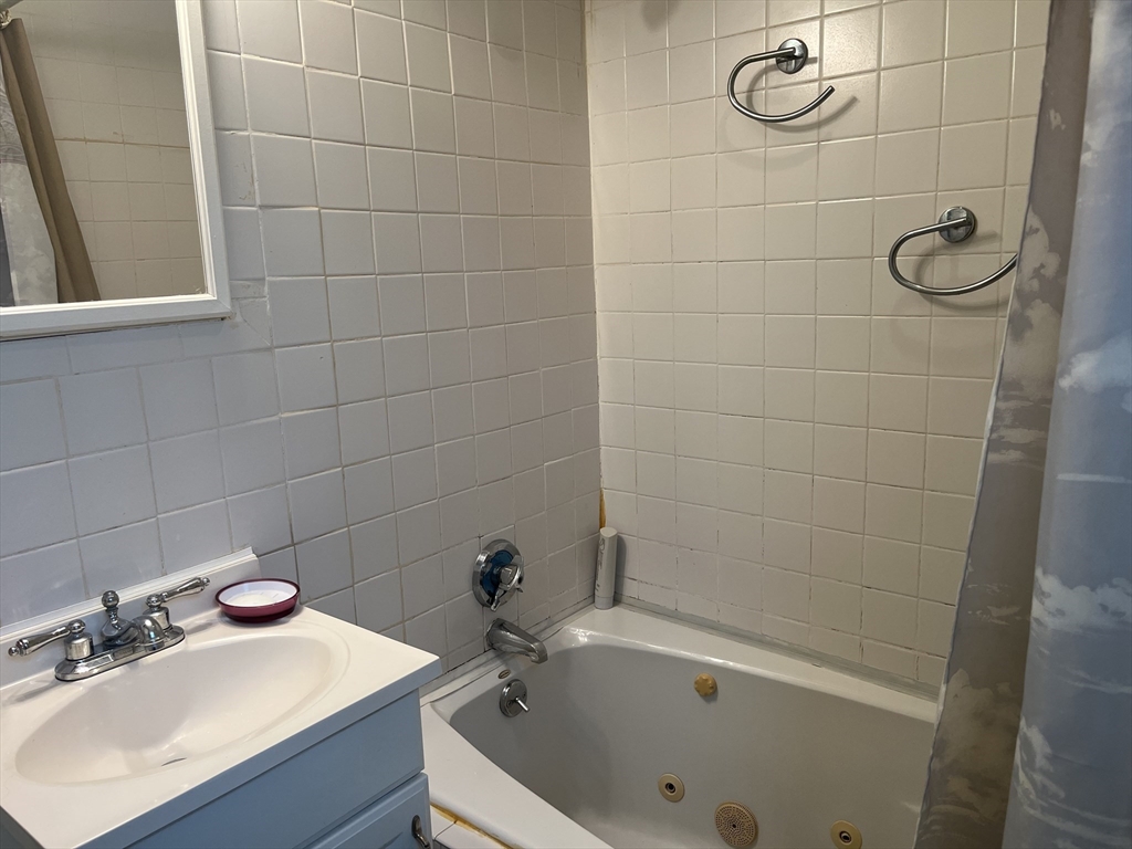 136 West Street Randolph, MA 02368 - Photo 10 of 13 a bathroom with a sink shower and bathtub