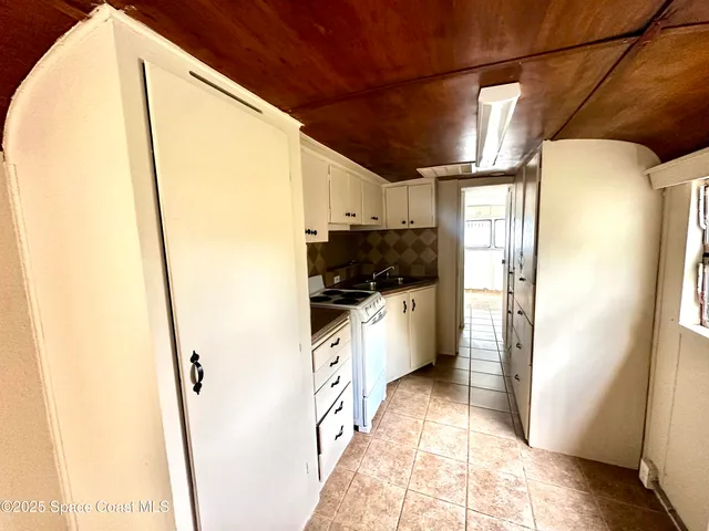 a kitchen with stainless steel appliances a refrigerator and a cabinets
