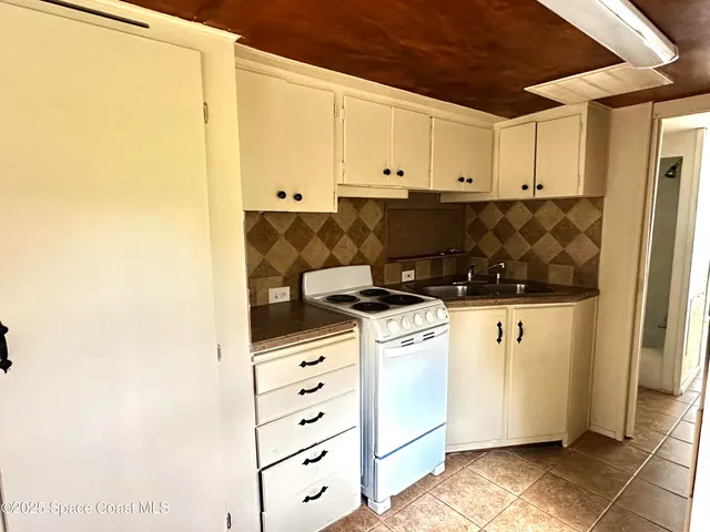 a kitchen with stainless steel appliances white cabinets and a refrigerator