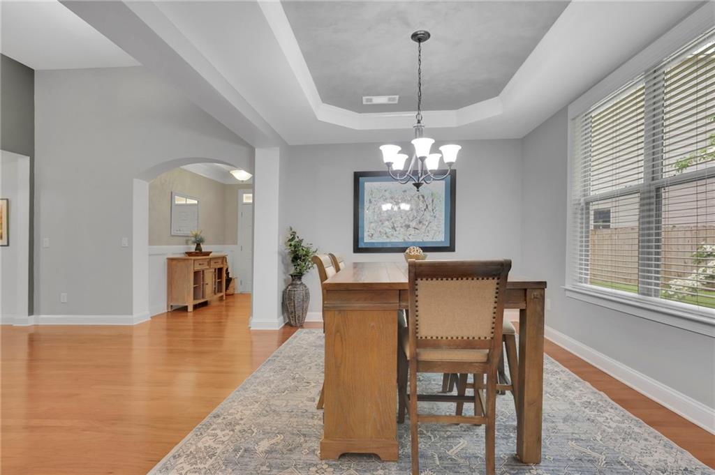 6255 Allison Road Cumming, GA 30040 - Photo 6 of 36 a view of a dining room with furniture and a chandelier
