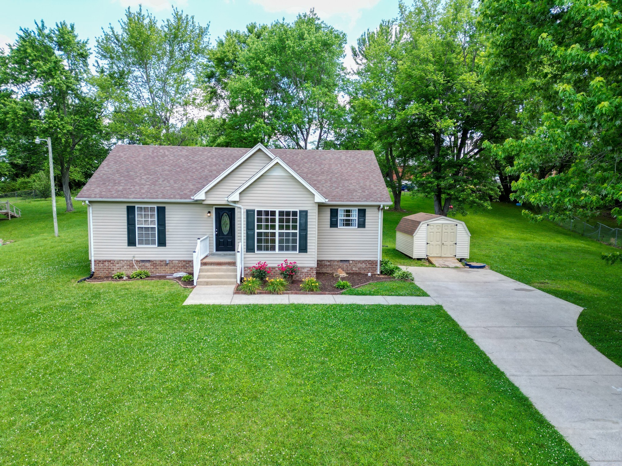 a front view of a house with yard and green space