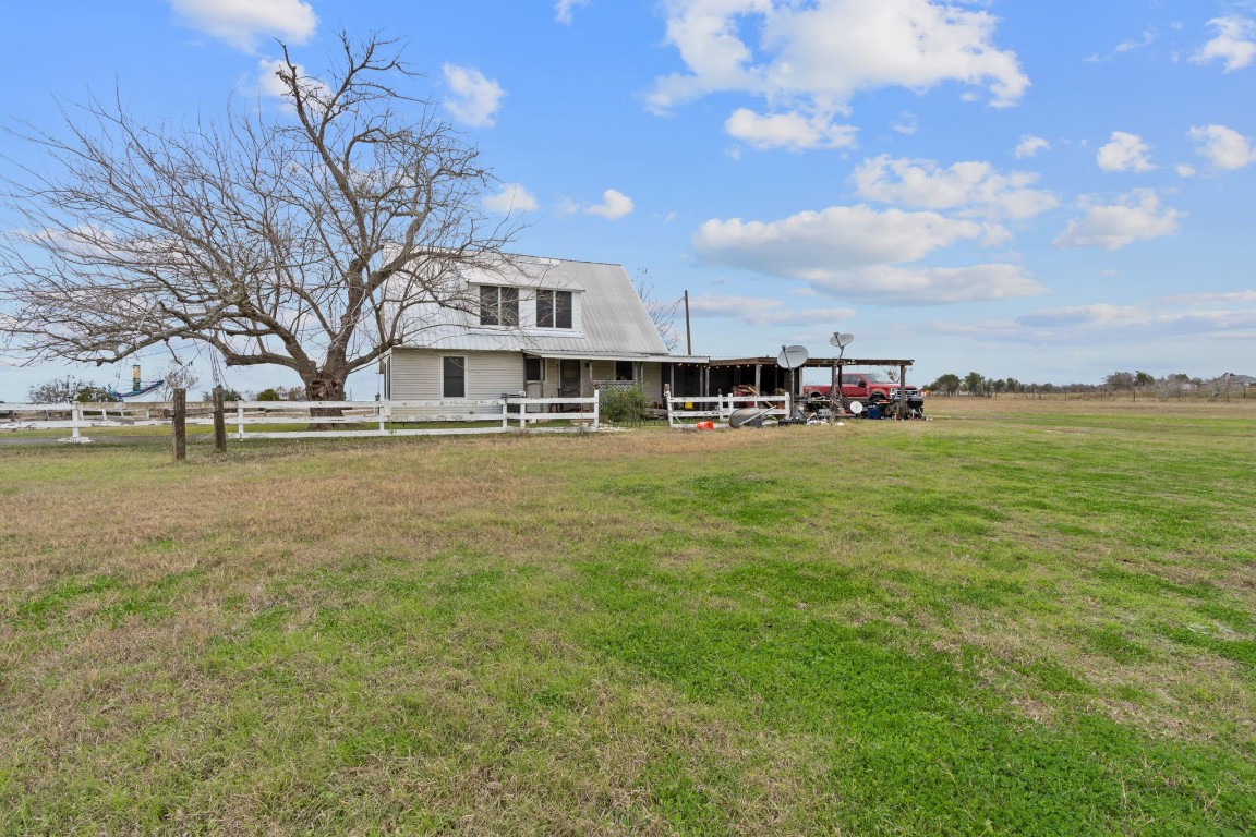 a view of a house with yard and sitting area