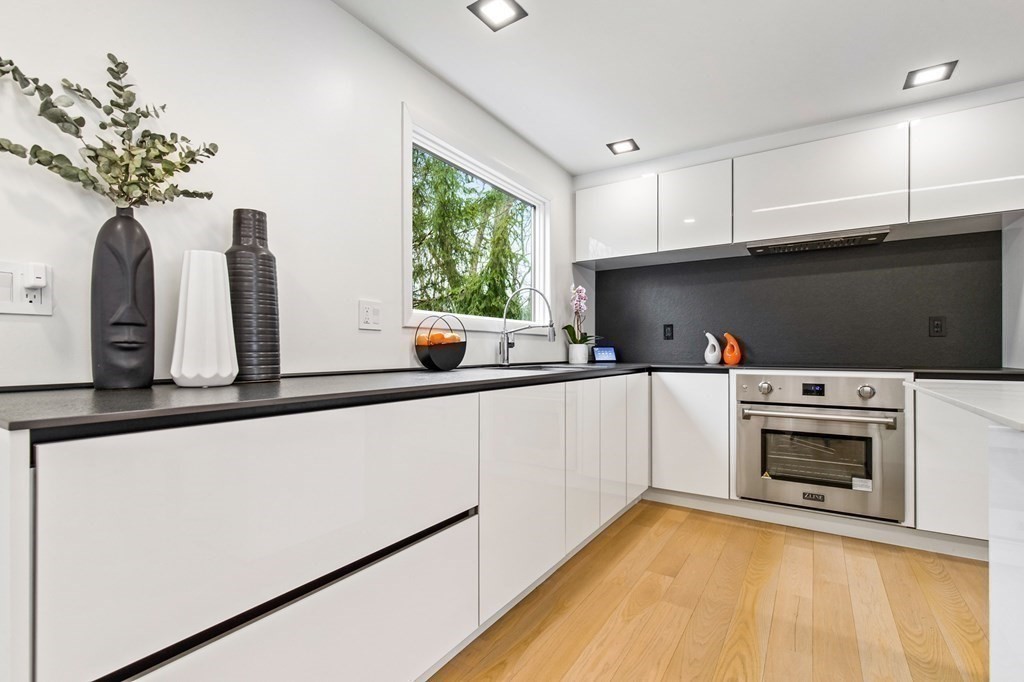 a kitchen with stainless steel appliances a white refrigerator sink and cabinets