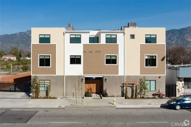 a couple of cars parked in front of a building