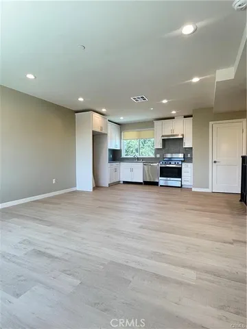 a view of kitchen with stainless steel appliances refrigerator and microwave