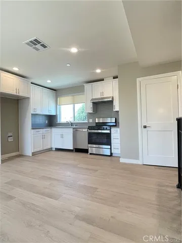 a view of kitchen with wooden floor