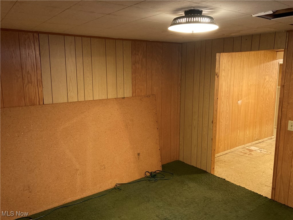 2547 Mayfair Road Akron, OH 44312 - Photo 42 of 50 Empty room featuring light colored carpet and wooden walls