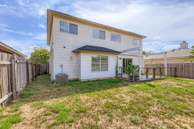 a view of a house with backyard porch and sitting area