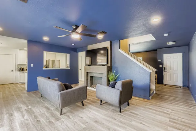 a living room with furniture and a chandelier