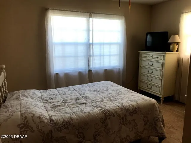 a bedroom with a bed and television