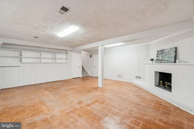wooden floor in an empty room with a fireplace