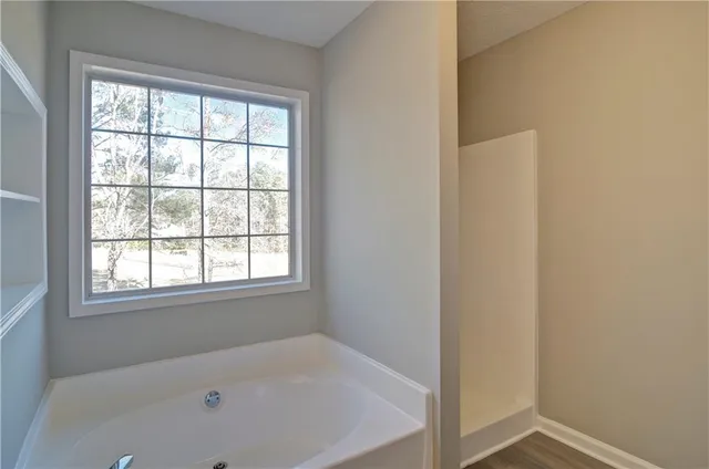 an empty room with a ceiling fan and a fan