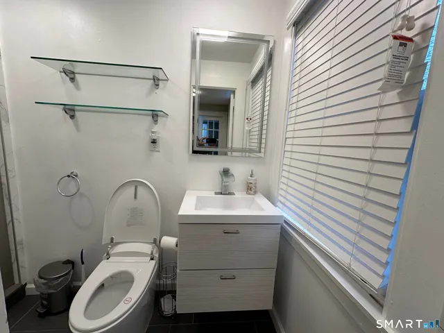 a bathroom with a sink toilet and shower