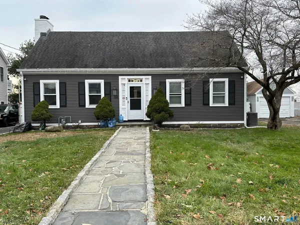 a front view of house with yard and green space