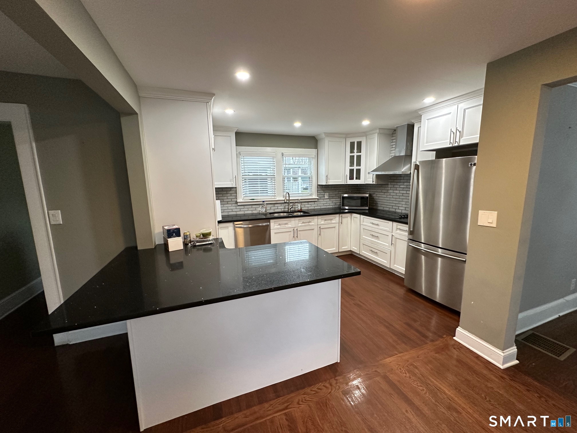 70 Hawthorne Street Bridgeport, CT 06610 - Photo 2 of 23 a kitchen with stainless steel appliances granite countertop a sink a stove a refrigerator and a microwave