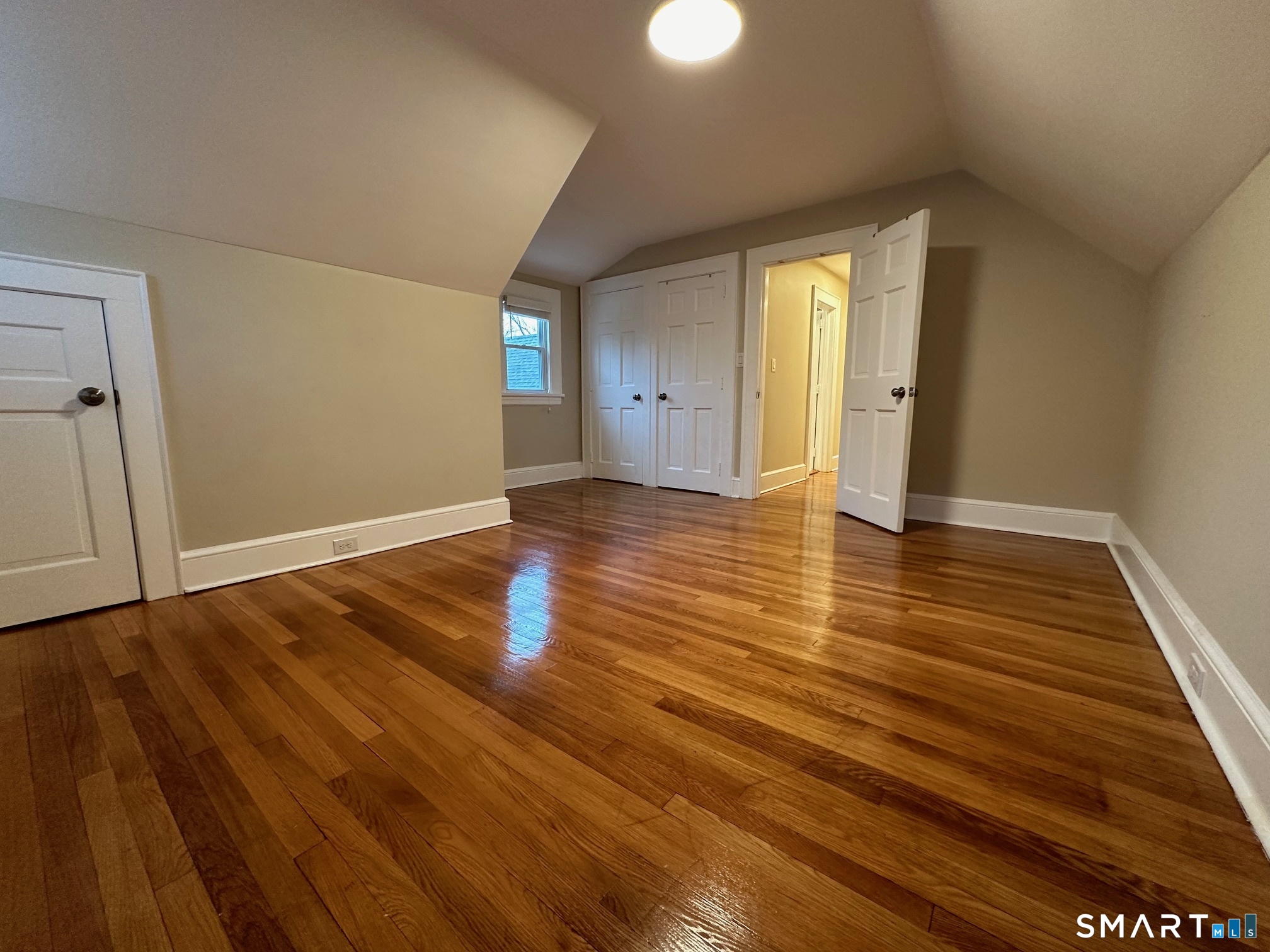 70 Hawthorne Street Bridgeport, CT 06610 - Photo 22 of 23 a view of an empty room with wooden floor and a window