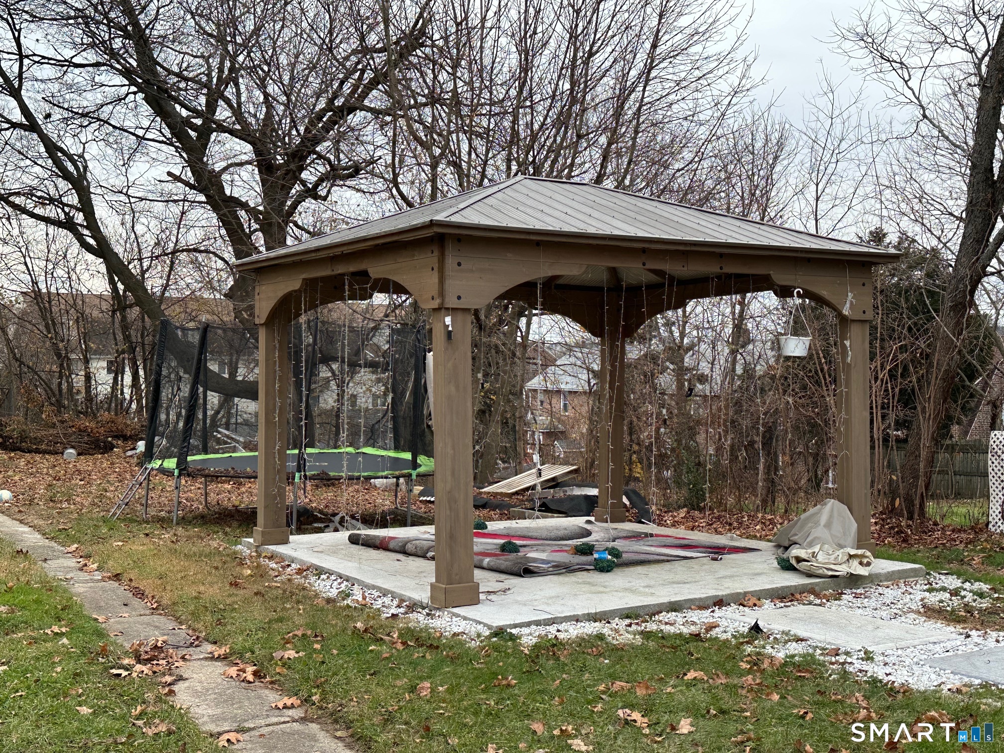 70 Hawthorne Street Bridgeport, CT 06610 - Photo 3 of 23 a view of a wooden house with a yard and large tree