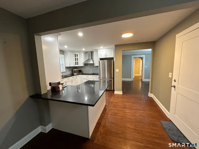 a kitchen with sink cabinets and stainless steel appliances