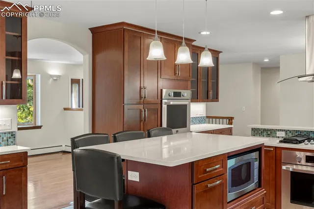 a kitchen with stainless steel appliances granite countertop a stove a refrigerator and a refrigerator