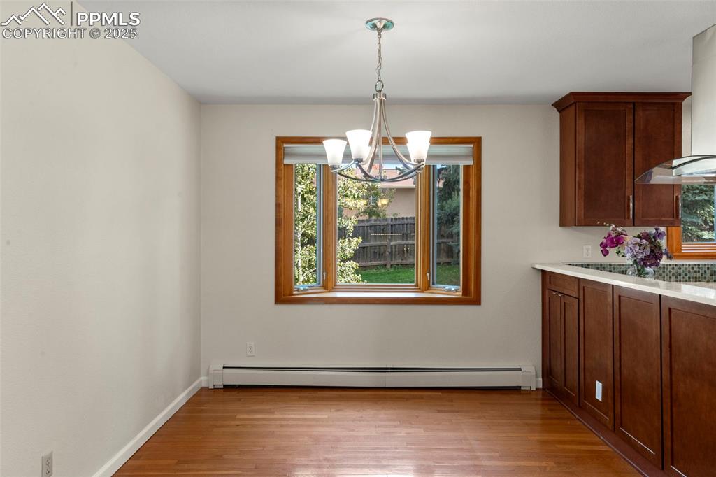 327 Clarksley Road Manitou Springs, CO 80829 - Photo 10 of 26 a view of an empty room with wooden floor and a window